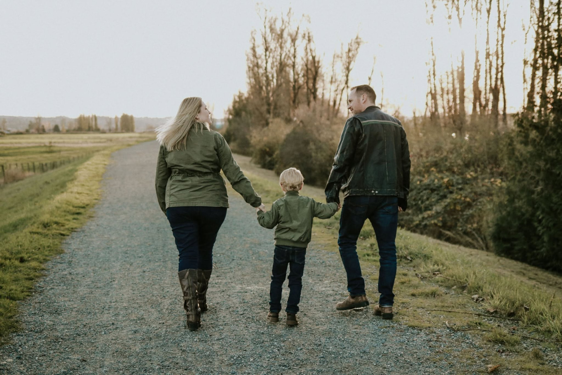 Family of three walking a country road at sunset — McManus Photography