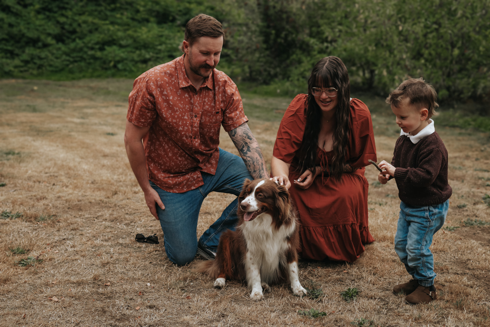 Family with dog in field