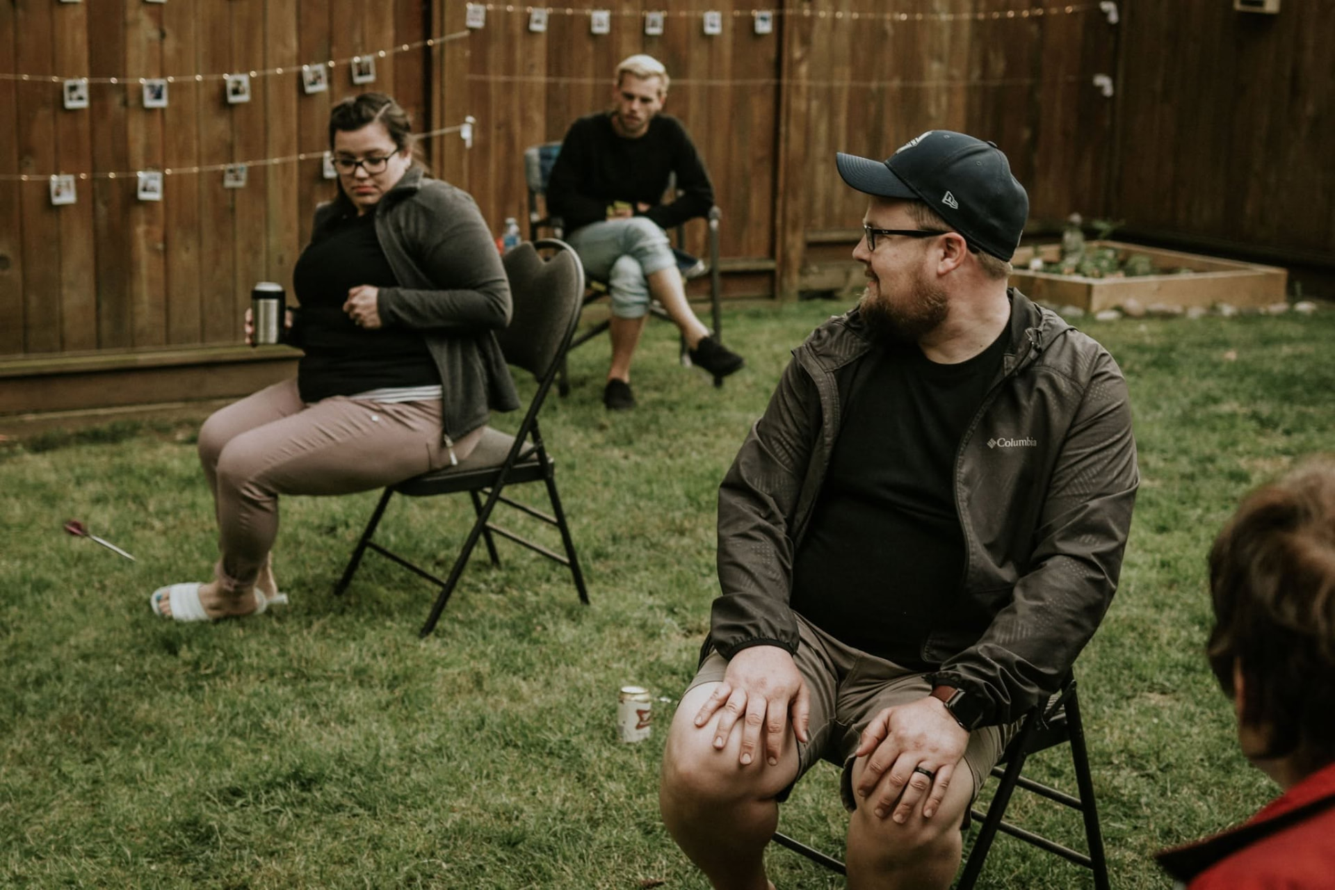 Guests seated on the lawn during a backyard wedding