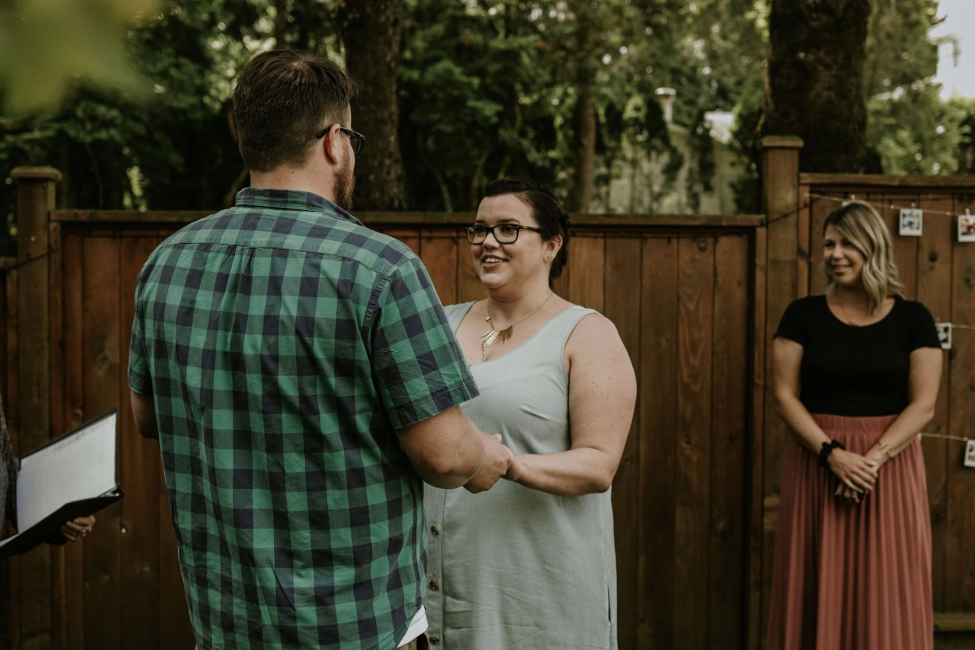 Couple exchanging vows during a backyard wedding ceremony