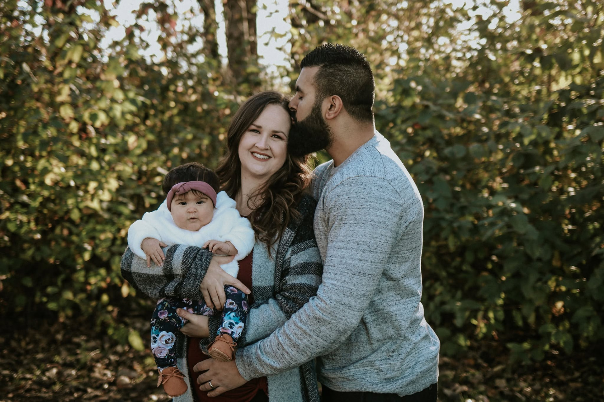 Parents holding their baby in autumn light — McManus Photography