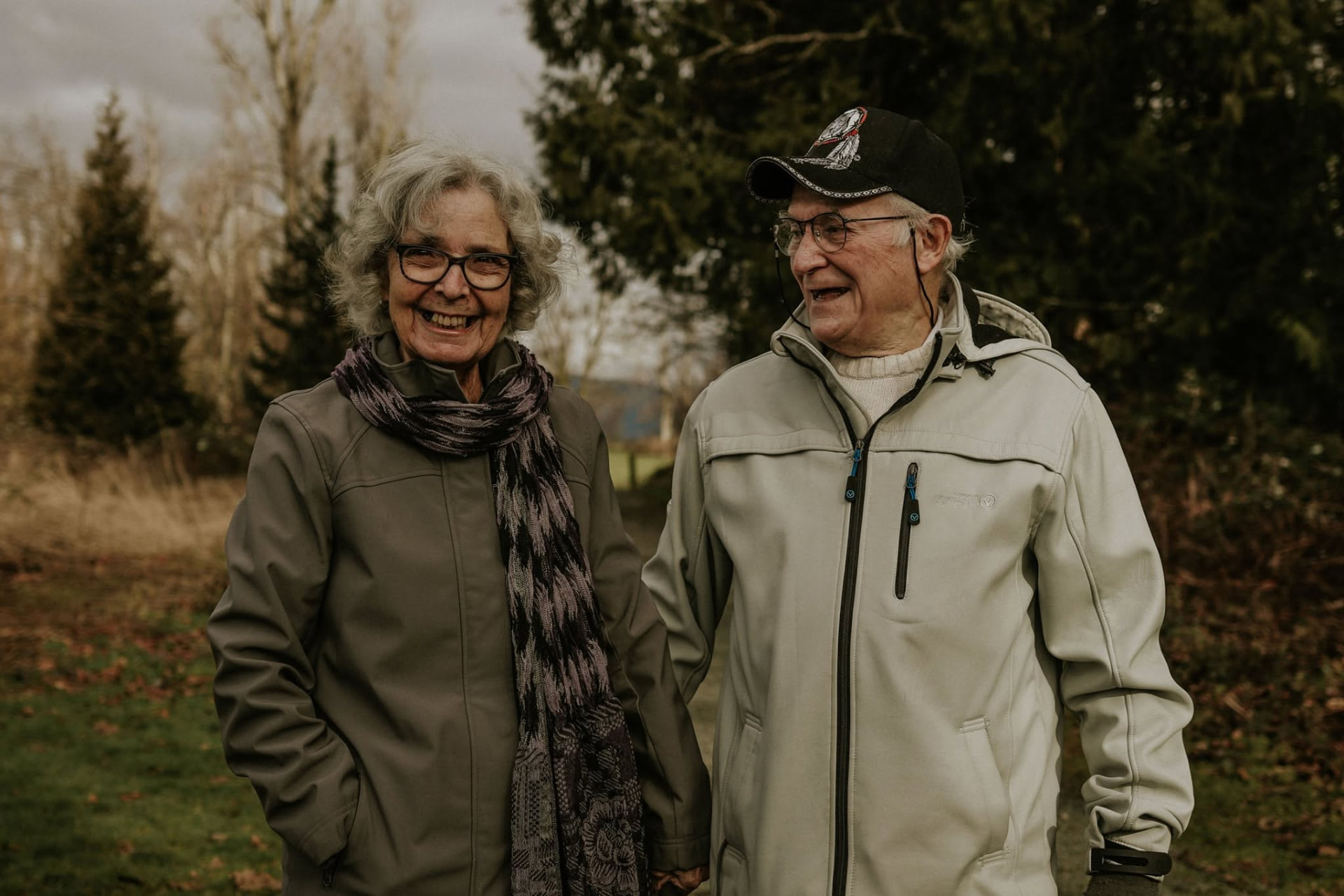 Longtime couple laughing together on a winter walk — McManus Photography