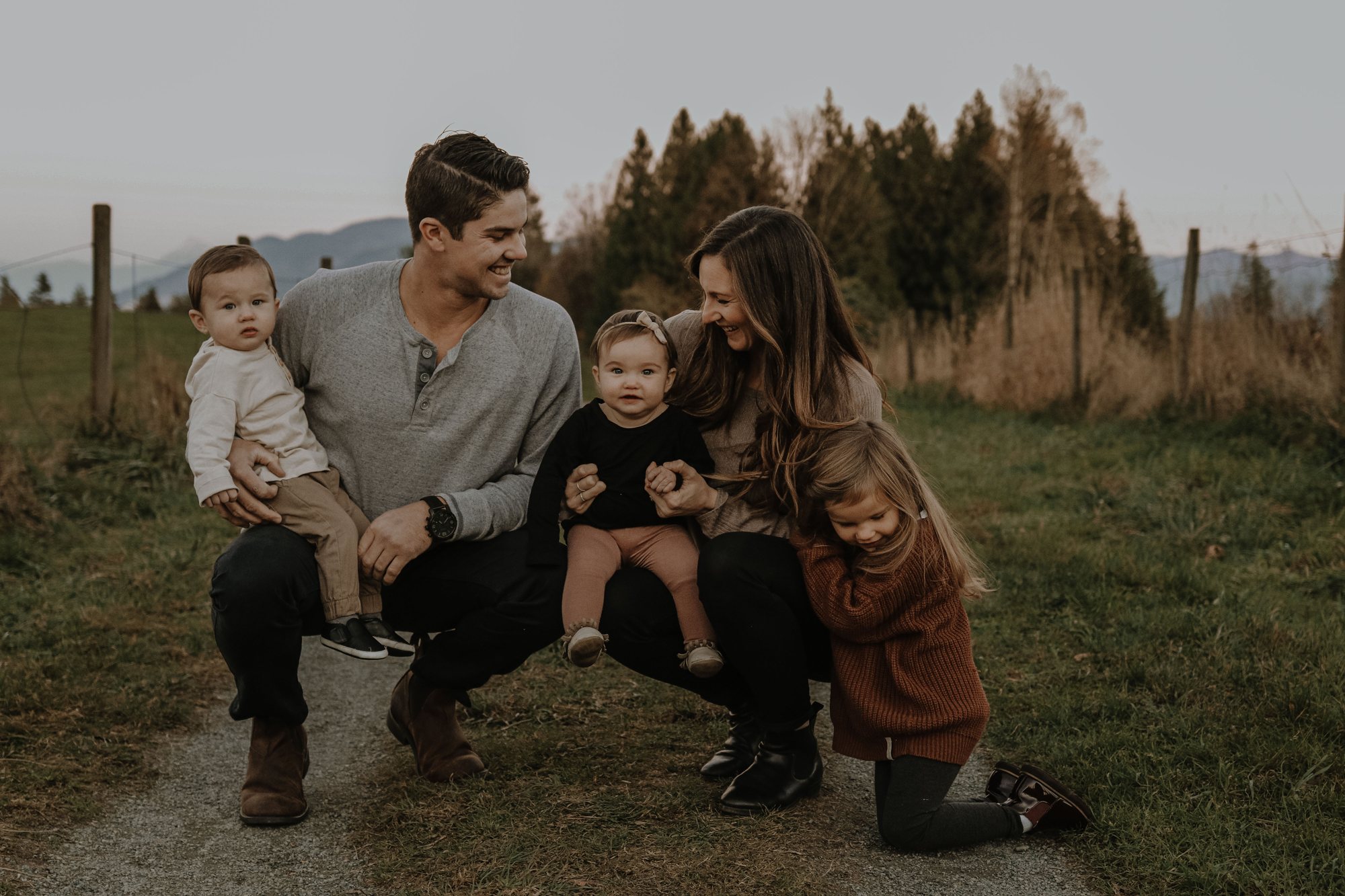 Family by the fence in golden light — McManus Photography