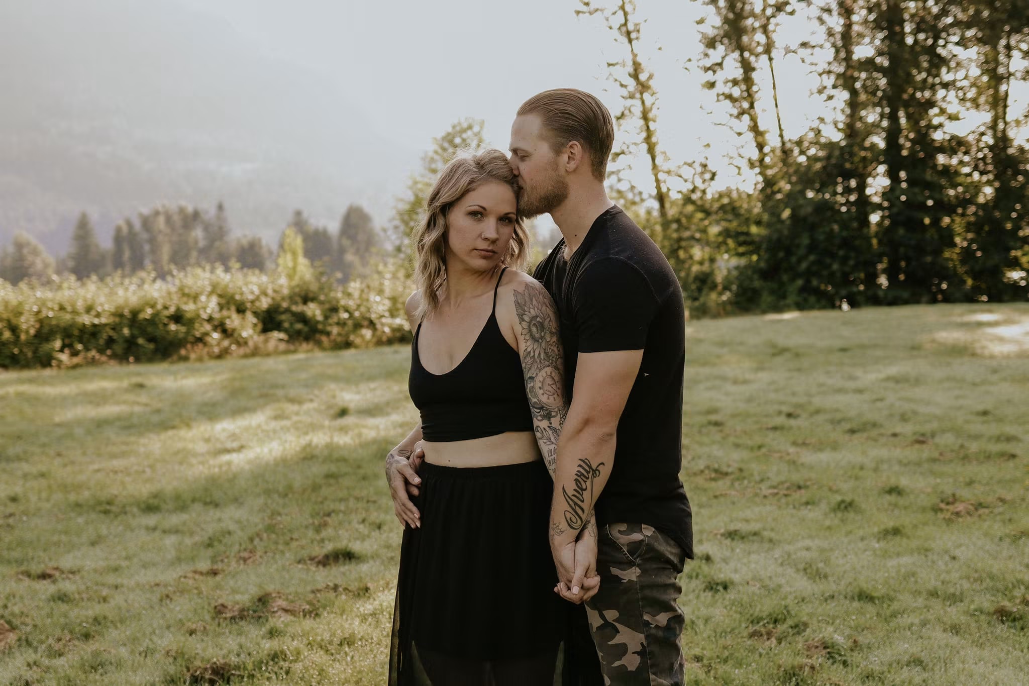 Couple embracing in a mountain meadow at sunrise — McManus Photography