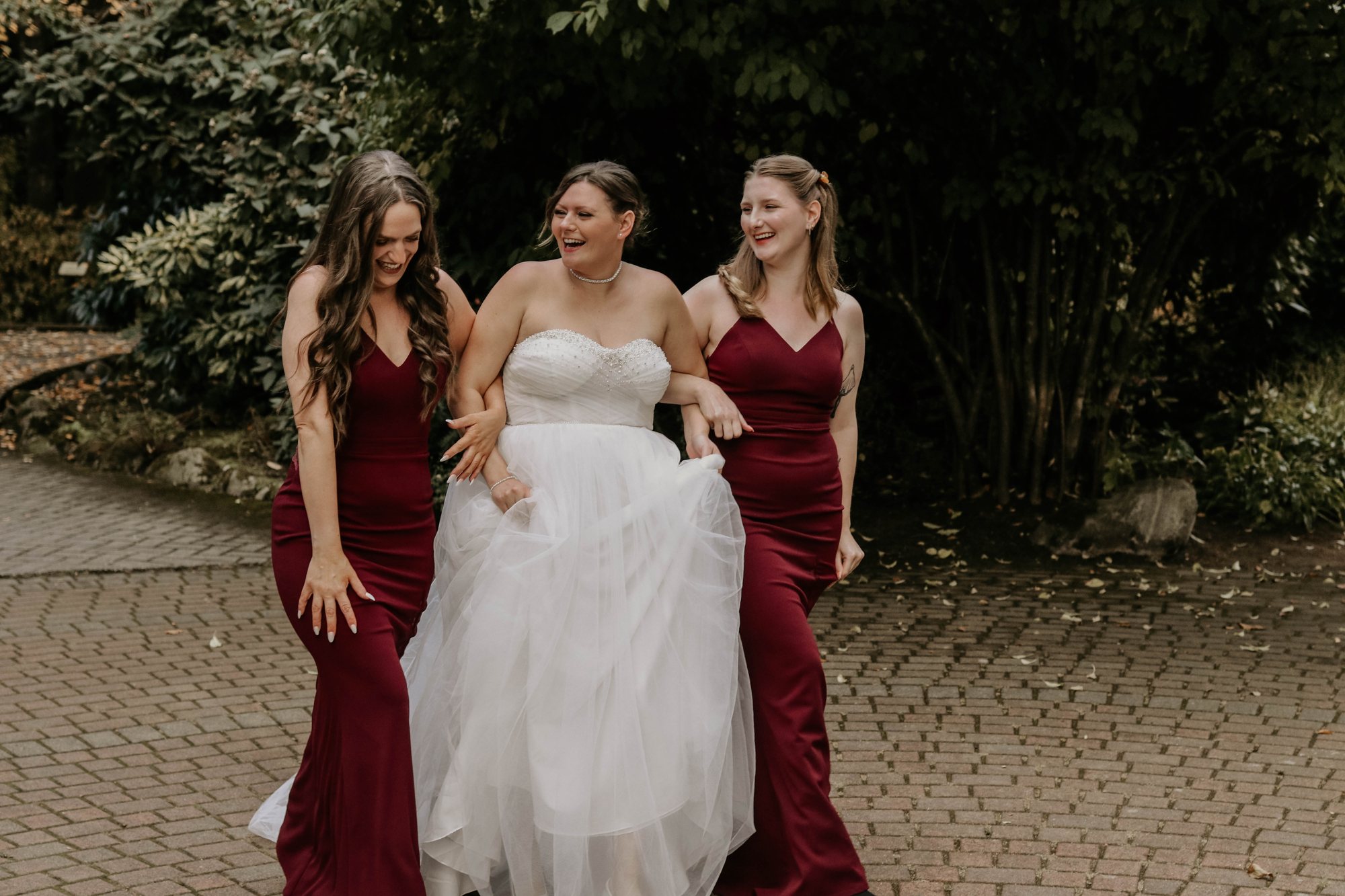 Newlyweds kissing as their wedding party celebrates