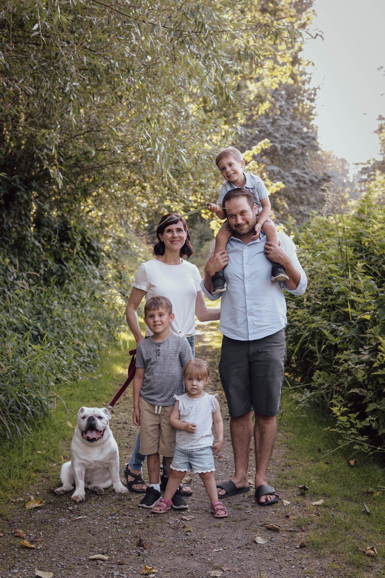 Family on an autumn path with their dog