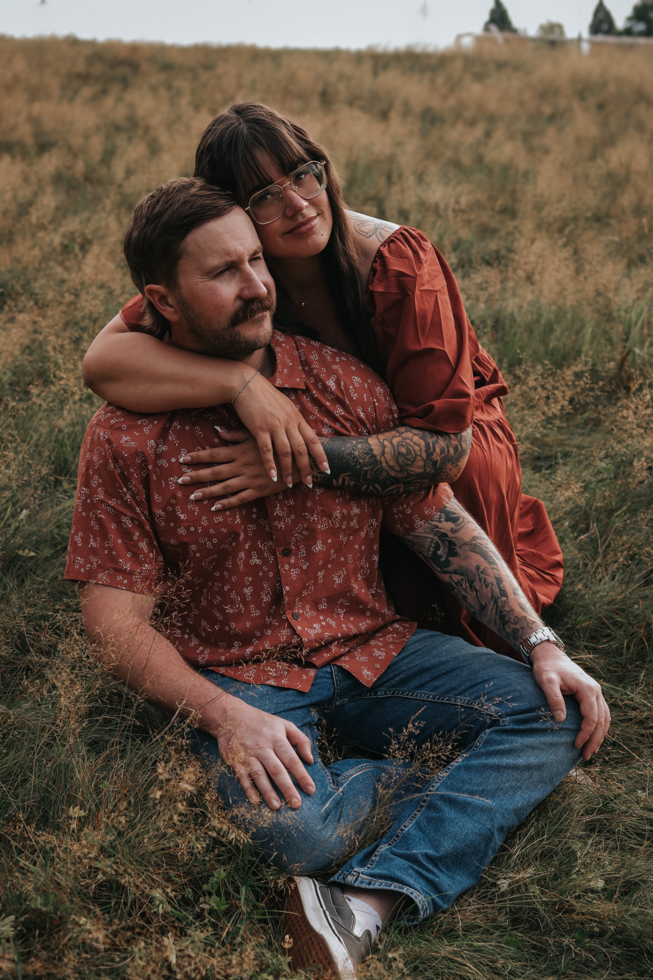 Couple embracing in a grassy field