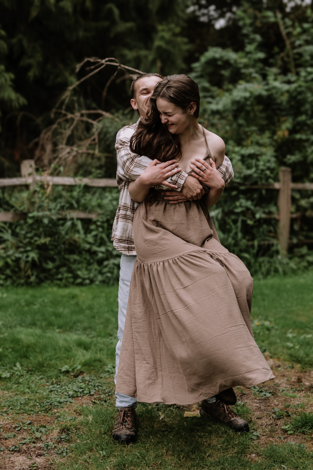 Man dipping and hugging his partner on the lawn