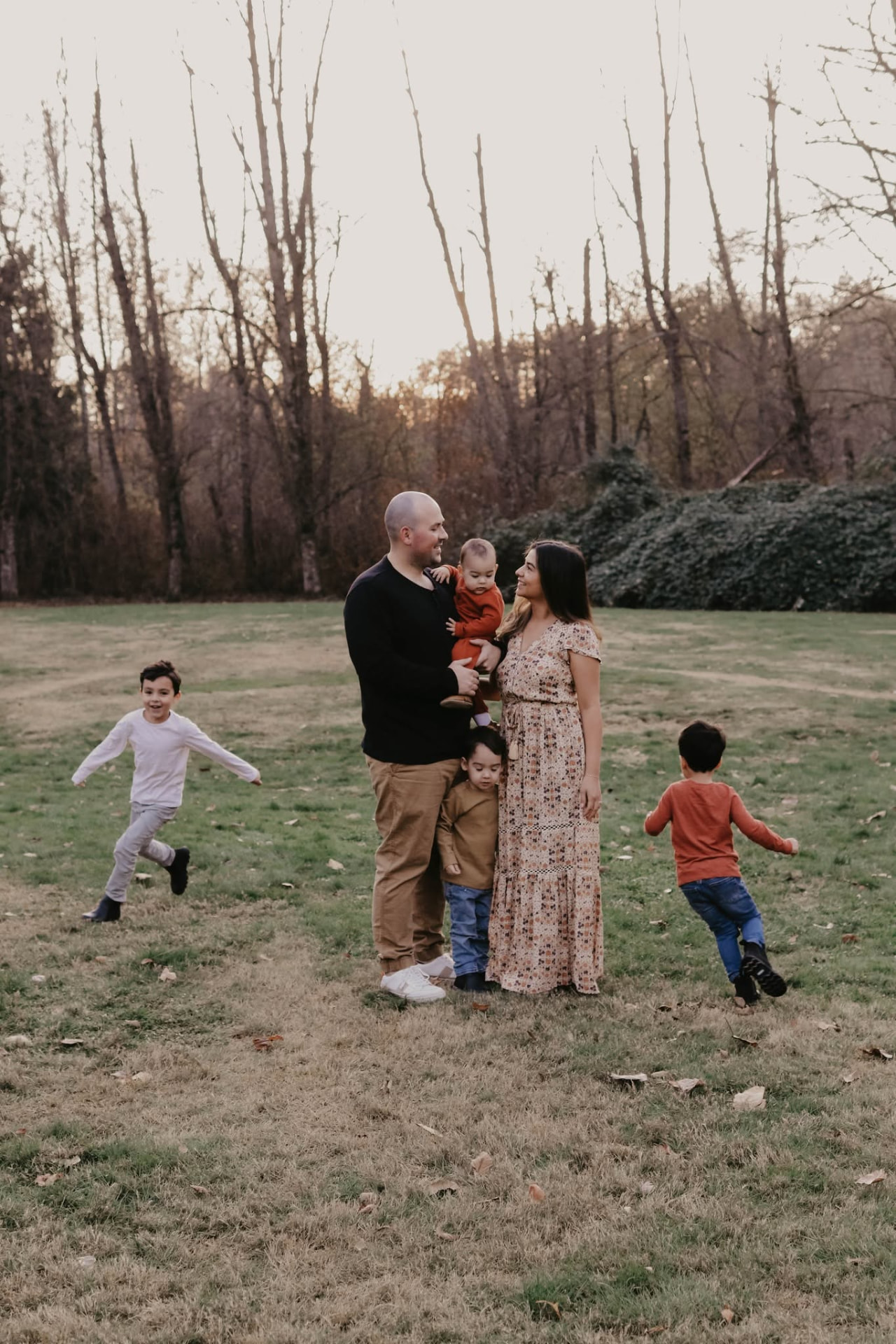 Family photographed together in a golden autumn field at Aldergrove Regional Park