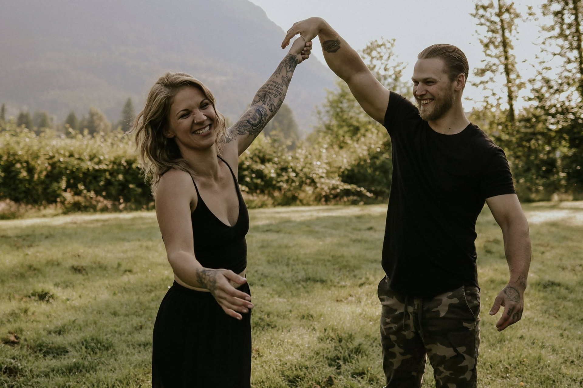 Couple dancing and twirling in a mountain meadow at golden hour — McManus Photography
